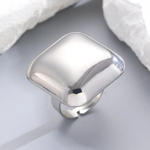 Macro detail of glossy silver square ring with polished surface and adjustable band