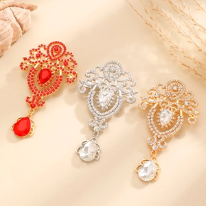 Vintage crystal teardrop brooches with rhinestone accents in red and white finishes
