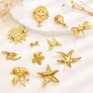 Elegant gold stainless steel brooches with nature motifs and secure pin backing