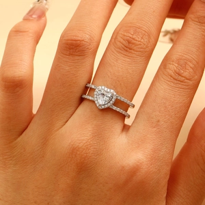 Close-up of a silver heart ring with double band design and zircon pave setting
