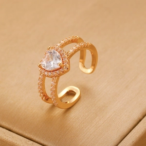 Detail of vintage gold heart ring with zircon stones and double-layered adjustable band