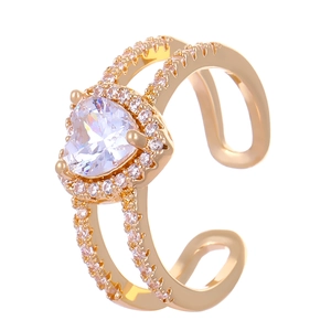Detailed close-up of golden heart ring with sparkling zircon stone and adjustable double band