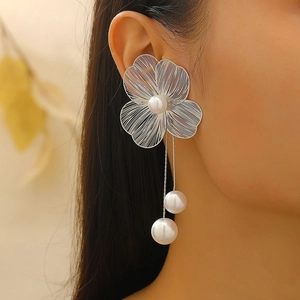 Close-up of elegant silver wire flower ear cuff with pearls and long tassel drop chains
