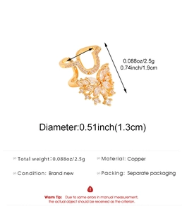 Macro detail of golden butterfly nail ring with sparkling cubic zirconia inlays