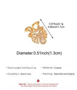 Detailed view of copper nail ring with white zircons and teardrop charms in gold finish