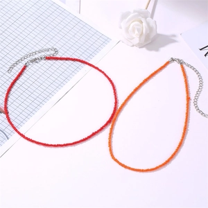 Ethnic beaded choker necklaces in vibrant red and orange with silver lobster clasp extension