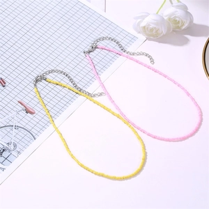 Bohemian beaded choker necklace in pink and yellow with adjustable silver chain and clasp