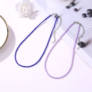 Detailed view of colorful beaded necklaces with silver lobster clasps and extension chains