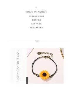 Macro detail of a vintage daisy sunflower pendant on a double-strand black cord bracelet