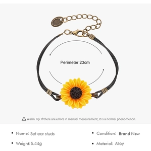 Detail view of sunflower bracelet with black cord and adjustable bronze alloy clasp