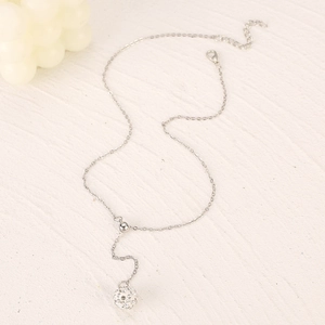 Detail of silver Y-shaped necklace with sliding bead and crystal-studded Shamballa pendant