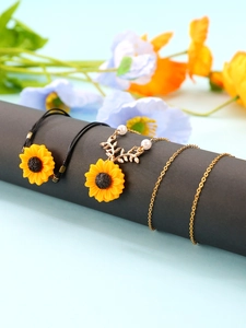 Detailed view of sunflower jewelry set featuring resin petals and elegant gold chain