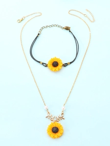 Detail of yellow sunflower jewelry set with black woven cord and gold pearl chain