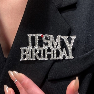 Sparkling silver birthday brooch with IT'S MY BIRTHDAY crystals on black suit lapel