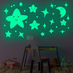 Luminous wall stickers with smiling stars and moon glowing in a dark kid's bedroom