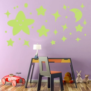 Detailed view of luminous wall stickers with smiling moon and stars in a child's bedroom