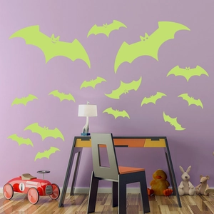 Detailed view of fluorescent bat wall decals in various sizes for Halloween decor