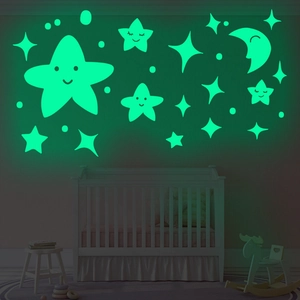 Luminous wall stickers featuring smiling moon and stars glowing in dark nursery room