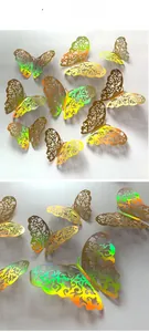 Detail of 3D laser-cut golden butterfly wall stickers with holographic rainbow effect