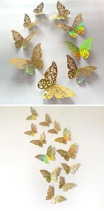 Detail of 3D gold hollow butterfly wall stickers with intricate laser-cut floral patterns