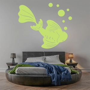 Glow-in-the-dark koi fish wall sticker with bubbles above a bed in a modern bedroom