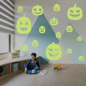 Luminous Halloween pumpkin wall decals showing glowing green stickers in a kids bedroom