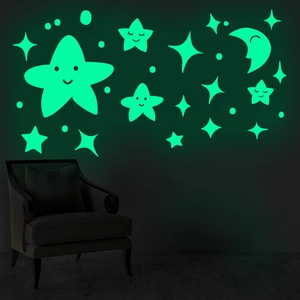 Detail showing glowing smiley moon and stars stickers in a dark room environment