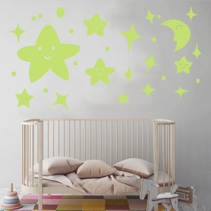 Luminous wall stickers with smiling stars and moon in a cozy nursery room setting