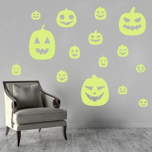 Luminous Halloween pumpkin wall stickers glowing in dark on a grey living room wall