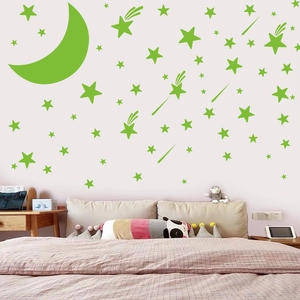 Luminous wall stickers featuring moon and stars for bedroom decor in bright green glow