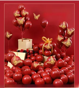 Detail of hollow 3D gold butterfly wall stickers on red balloons for festive decoration
