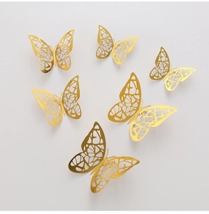 Detail view of 3D golden hollow butterfly wall stickers with intricate laser-cut patterns