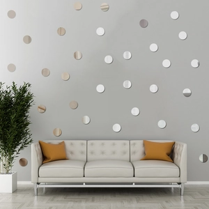Modern wall decor featuring circular silver and champagne acrylic mirror stickers on a wall