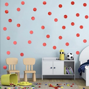 Modern red circular acrylic mirror wall stickers applied on a light blue room wall