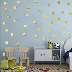 Detailed view of champagne gold round acrylic mirror wall stickers in a cozy nursery