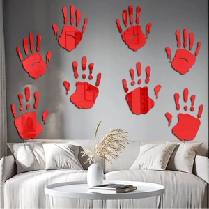 Detail view of 8 red acrylic bloody handprint mirror stickers on a living room wall