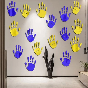 Detail of yellow and blue acrylic handprint mirror wall stickers for festive room decor
