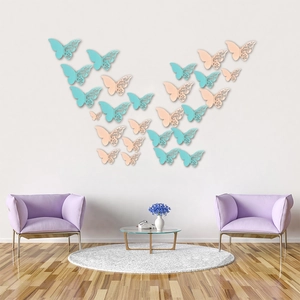 3D hollow pearl paper butterflies in mint and pink arranged on a white living room wall