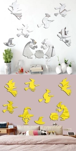 Close-up of witch silhouette acrylic mirror wall decals in silver and yellow finishes