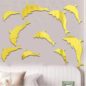 Detail of 10 golden acrylic dolphin mirror wall stickers on a bedroom background