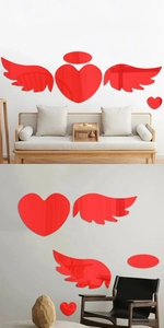 Detailed view of red acrylic heart and angel wing mirror wall stickers on a grey wall