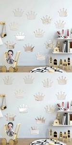 Macro detail of various sizes of silver crown mirror wall stickers in a cozy nursery room