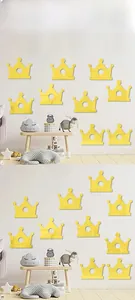 Golden acrylic crown mirror stickers arranged as wall decor in a bright children's room
