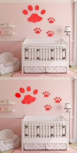 Close-up of red acrylic mirror paw print wall stickers in a nursery bedroom layout