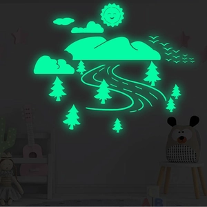 Luminous wall stickers featuring green glowing mountains and trees in a dark nursery