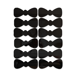 Detailed macro view of 12 black bow-tie acrylic mirror wall stickers with reflective finish