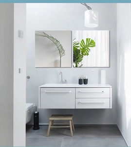 Detail of modern white wall-hung vanity unit with ceramic sink and three storage drawers