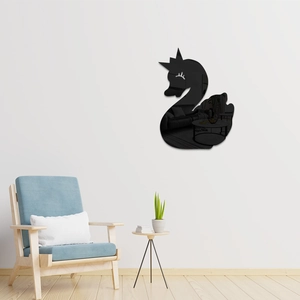 Close-up of black acrylic swan mirror sticker with crown and eyelash detail on wall