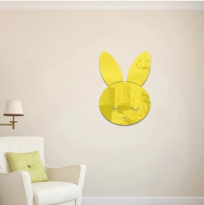 Detail of yellow rabbit acrylic mirror sticker with closed eyes for wall decoration