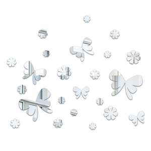 Macro detail of silver acrylic mirror wall stickers featuring butterfly and flower shapes